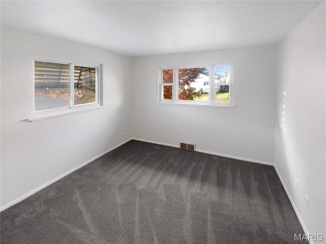 6448 Clifton Hills Dr, Saint Louis, MO 63139 - spare room featuring dark colored carpet and baseboards