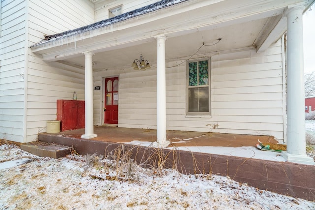 212 N Main St, Licking, MO 65542 - snow covered property entrance with a porch