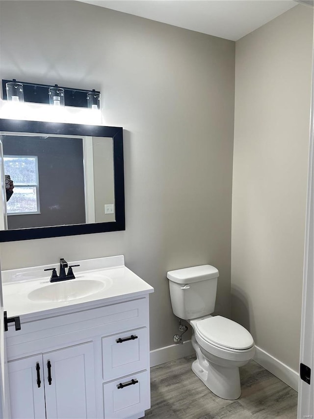 344 Rolling Knoll Rd, Washington, MO 63090 - half bathroom with baseboards, wood finished floors, toilet, and vanity