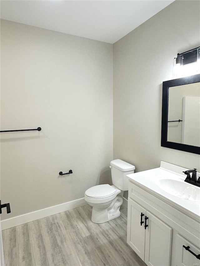 344 Rolling Knoll Rd, Washington, MO 63090 - bathroom featuring wood finished floors, toilet, vanity, and baseboards