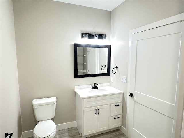 344 Rolling Knoll Rd, Washington, MO 63090 - half bathroom with wood finished floors, toilet, vanity, and baseboards