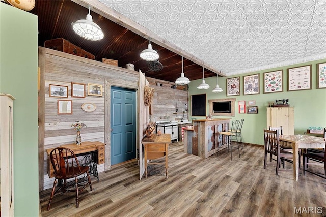 16683 Mill Rd, Marthasville, MO 63357 - kitchen featuring wooden walls, wood finished floors, and pendant lighting