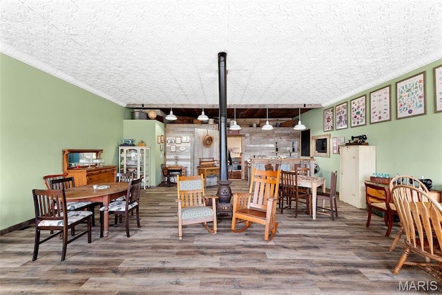 16683 Mill Rd, Marthasville, MO 63357 - dining room with wood finished floors, a wood stove, and an ornate ceiling