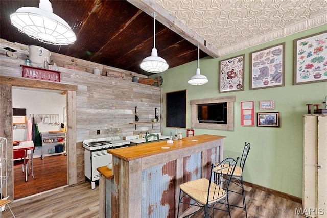 16683 Mill Rd, Marthasville, MO 63357 - kitchen with wooden walls, light wood-style floors, wood counters, a breakfast bar, and hanging light fixtures