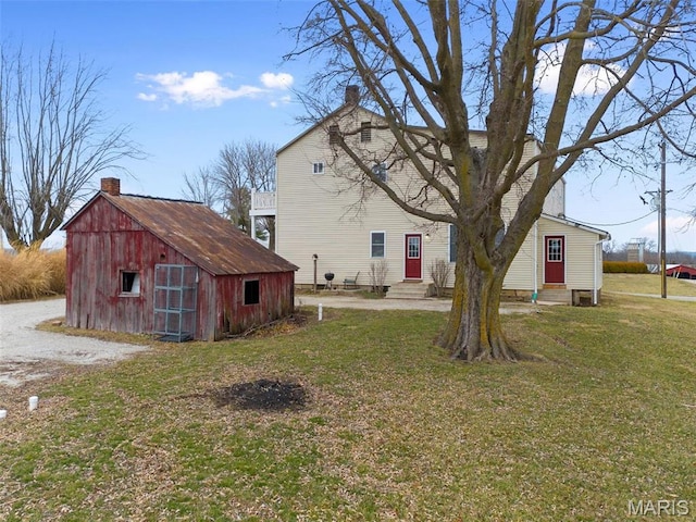 16683 Mill Rd, Marthasville, MO 63357 - rear view of property with entry steps, a lawn, and a storage shed