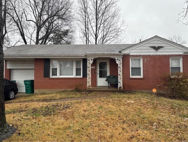 ranch-style house featuring an attached garage, brick siding, and a front lawn