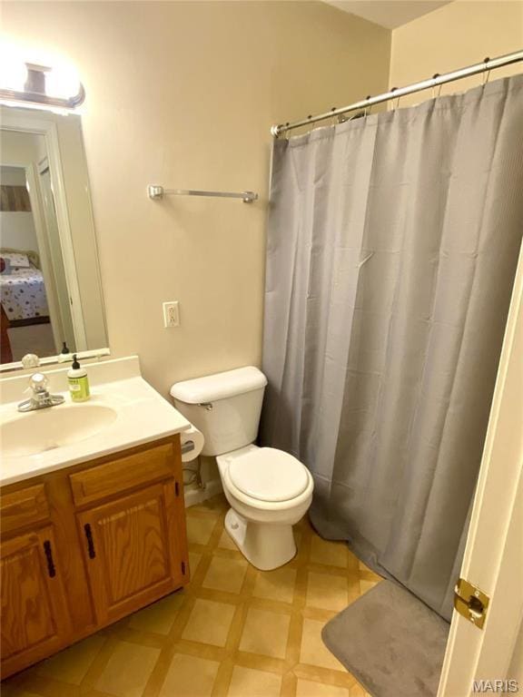 914 Pine St, Sikeston, MO 63801 - bathroom featuring toilet, vanity, tile patterned floors, and a shower with curtain