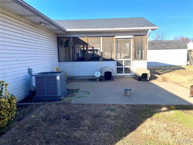 914 Pine St, Sikeston, MO 63801 - rear view of property with a sunroom, central air condition unit, and a shingled roof