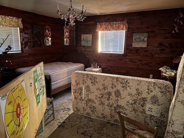 731 Buffalo Dr, Bismarck, MO 63624 - bedroom with wood walls, a textured ceiling, and a chandelier