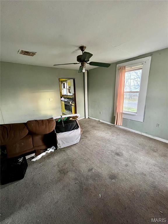 209 Mcgill St, Jerseyville, IL 62052 - living area featuring carpet, ceiling fan, and baseboards