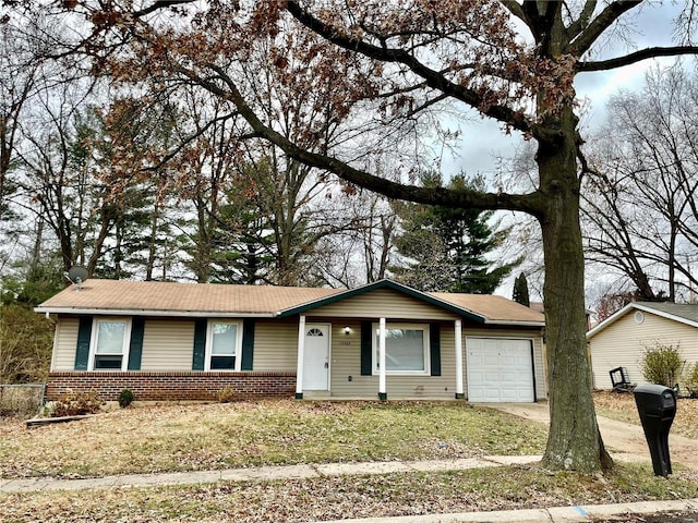 12065 El Camara Dr, Florissant, MO 63033 - ranch-style house featuring a garage, brick siding, a front lawn, and driveway