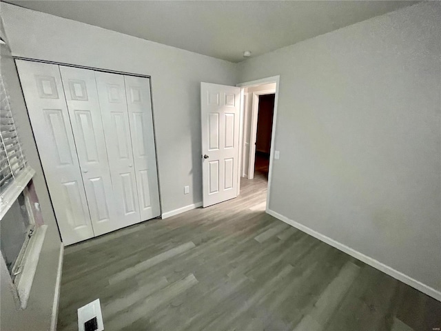 12065 El Camara Dr, Florissant, MO 63033 - unfurnished bedroom featuring baseboards, wood finished floors, and a closet