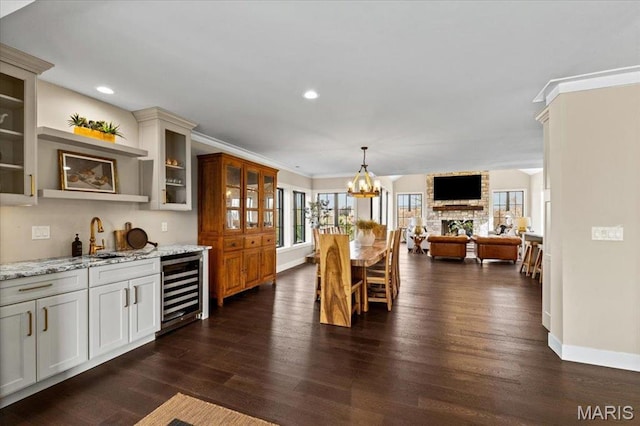 1824 Topping Rd, Saint Louis, MO 63131 - dining area featuring wine cooler, a chandelier, baseboards, wet bar, and recessed lighting