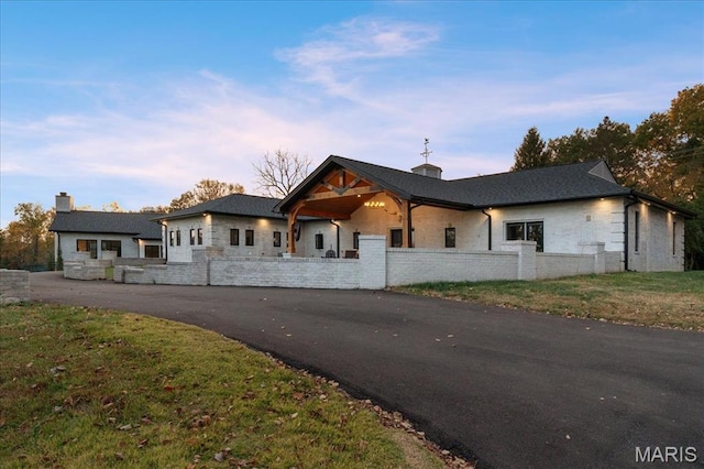 1824 Topping Rd, Saint Louis, MO 63131 - view of front of house featuring a fenced front yard, a chimney, and stone siding
