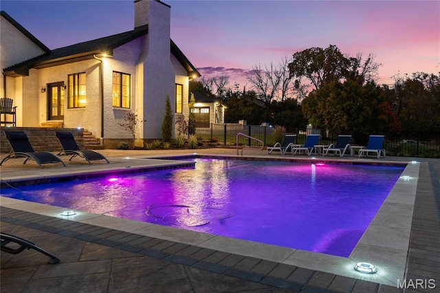 1824 Topping Rd, Saint Louis, MO 63131 - pool at dusk with fence and a patio