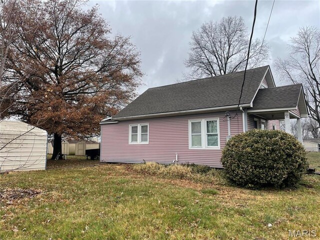 101 Cass St, Waterloo, IL 62298 - view of side of home with roof with shingles and a yard