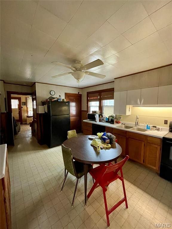 101 Cass St, Waterloo, IL 62298 - kitchen featuring black appliances, a sink, ceiling fan, light countertops, and brown cabinetry