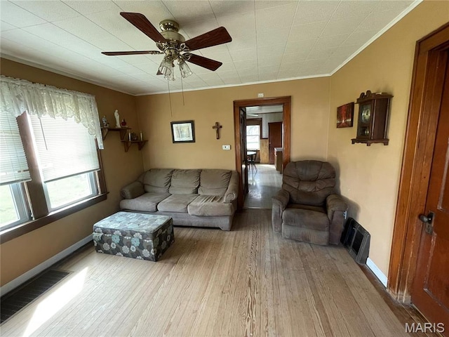 101 Cass St, Waterloo, IL 62298 - living area featuring healthy amount of natural light, wood finished floors, a ceiling fan, crown molding, and baseboards