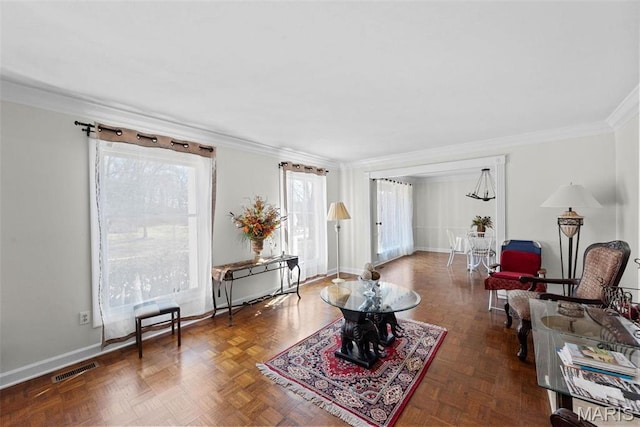 living room with crown molding and baseboards