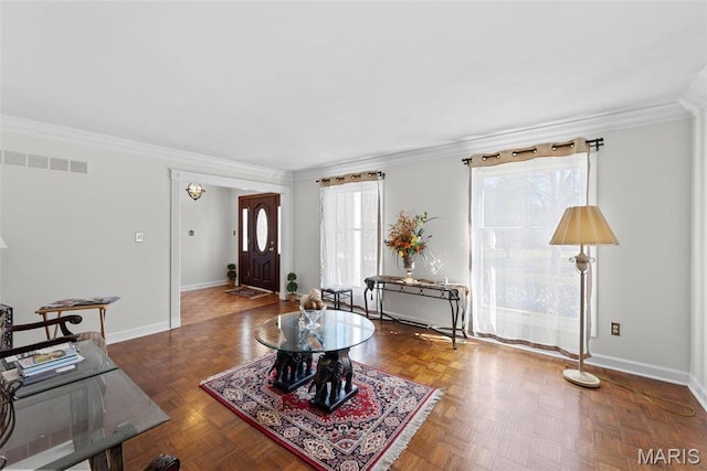 living area featuring crown molding and baseboards