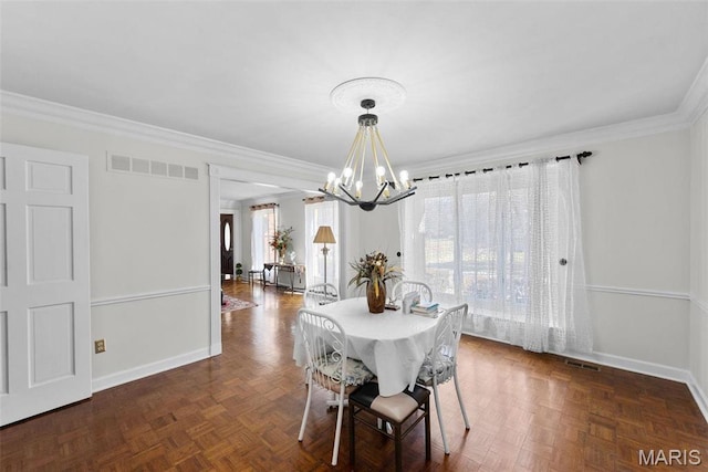 dining room featuring a chandelier, baseboards, and ornamental molding
