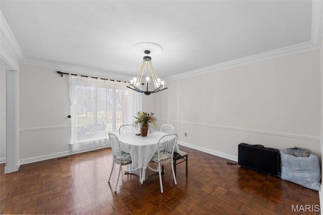 dining area featuring a chandelier, crown molding, and baseboards