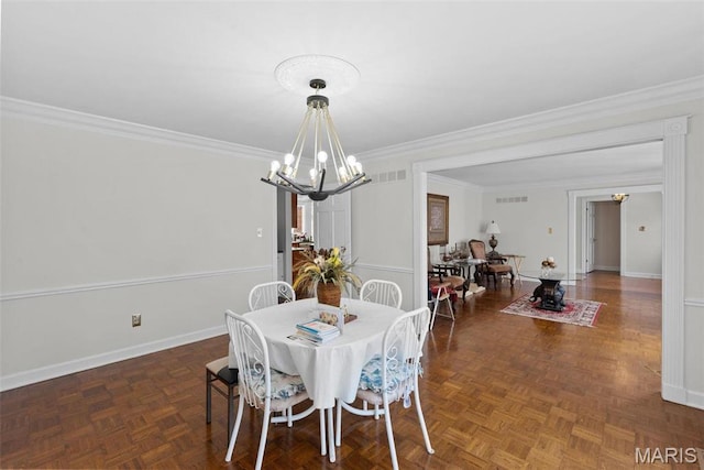 dining room with a chandelier, ornamental molding, and baseboards