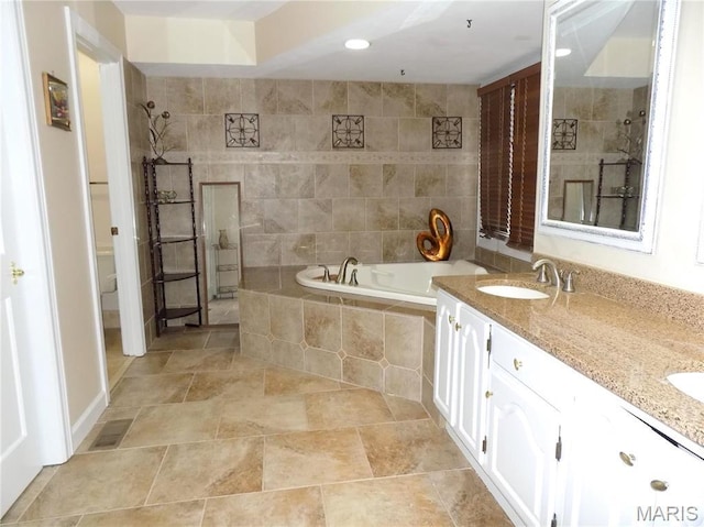 full bath with tiled shower, a garden tub, double vanity, and recessed lighting