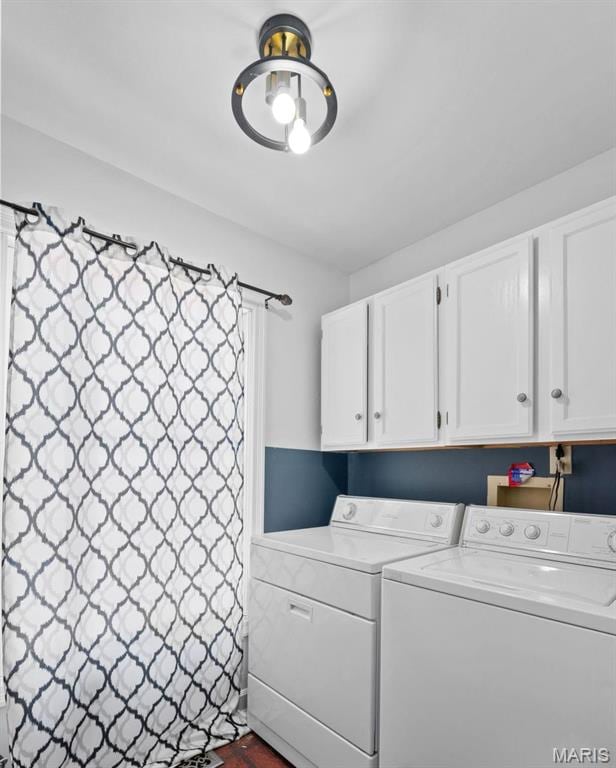 clothes washing area featuring cabinet space and washing machine and clothes dryer