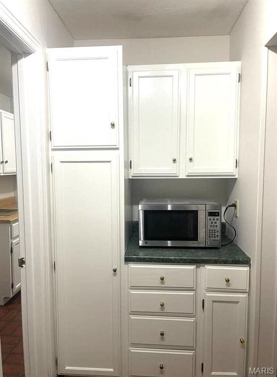 bar area featuring stainless steel microwave