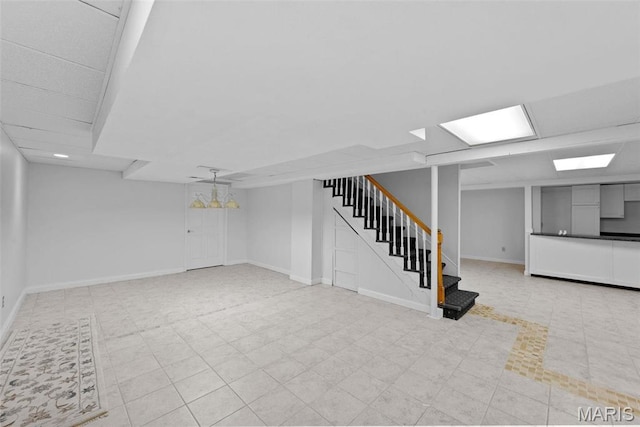 finished basement with stairs and baseboards
