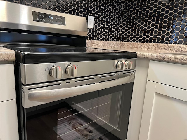 7100 Lexington Ave, Saint Louis, MO 63121 - kitchen view of stainless steel electric stove and backsplash