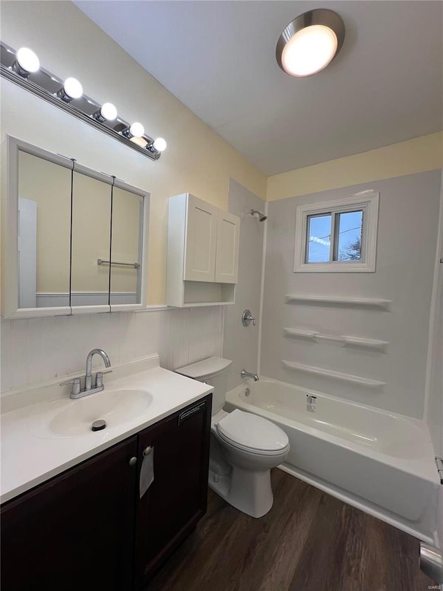 7100 Lexington Ave, Saint Louis, MO 63121 - full bathroom with wood finished floors, toilet, bathtub / shower combination, vanity, and backsplash