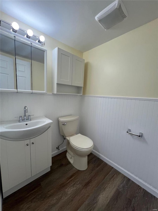 7100 Lexington Ave, Saint Louis, MO 63121 - half bathroom featuring wood finished floors, toilet, wainscoting, vanity, and baseboards