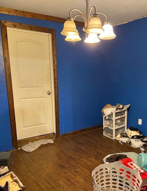 223 Burton St, Steele, MO 63877 - bedroom with wood-type flooring and a chandelier