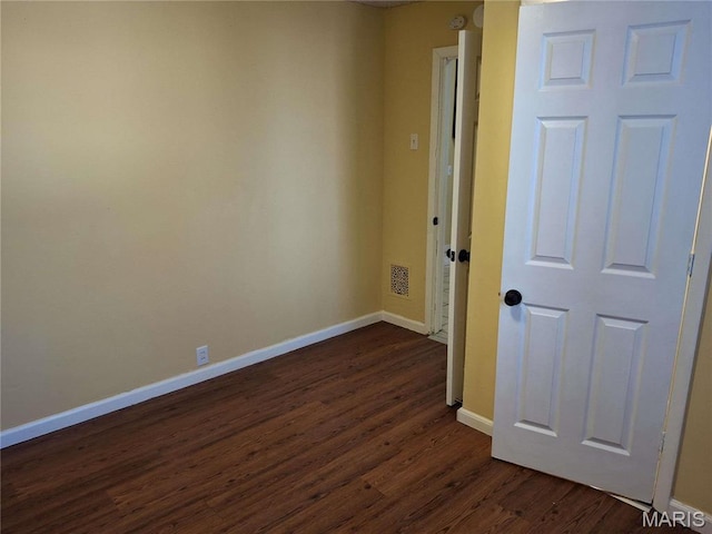 2709 Keokuk St, Saint Louis, MO 63118 - empty room with dark wood finished floors and baseboards
