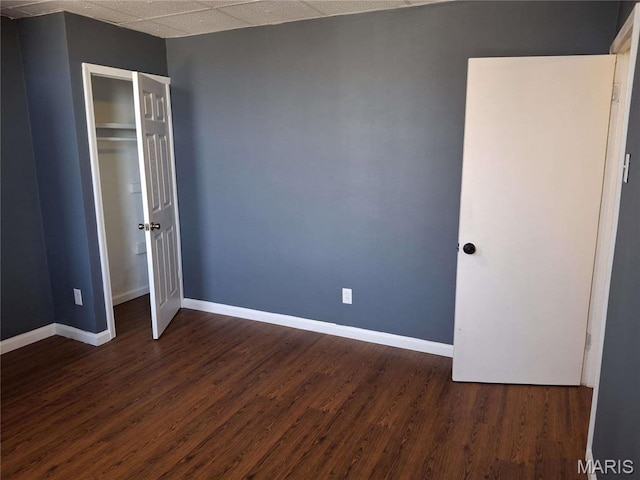 2709 Keokuk St, Saint Louis, MO 63118 - unfurnished bedroom featuring dark wood-style floors, baseboards, and a closet