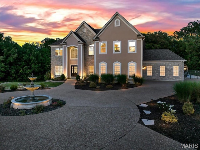 244 US Dr, Wentzville, MO 63385 - view of front facade with stone siding, curved driveway, and stucco siding