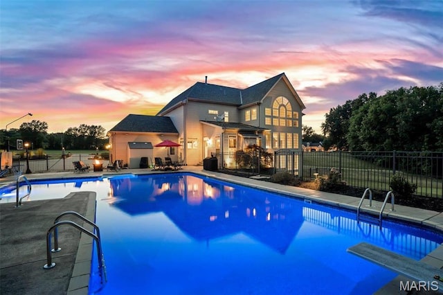244 US Dr, Wentzville, MO 63385 - pool at dusk featuring a patio area and fence