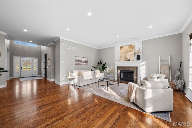 244 US Dr, Wentzville, MO 63385 - living room featuring wood finished floors, recessed lighting, a large fireplace, baseboards, and ornamental molding