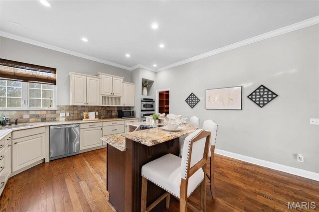 244 US Dr, Wentzville, MO 63385 - kitchen featuring stainless steel appliances, a breakfast bar, a center island, tasteful backsplash, and ornamental molding