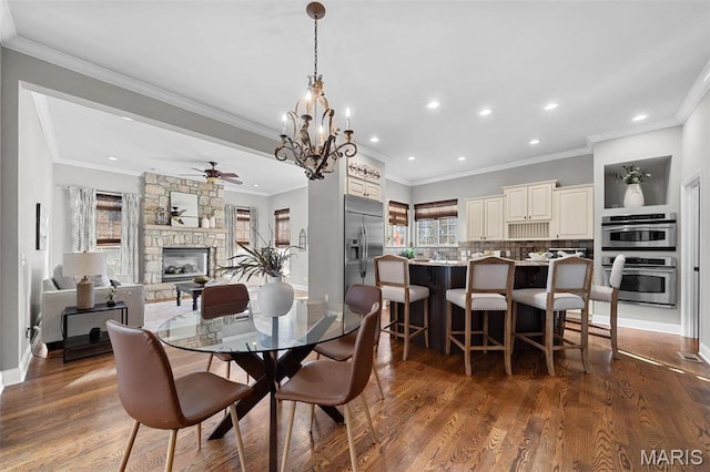 244 US Dr, Wentzville, MO 63385 - dining space featuring ceiling fan, a fireplace, wood finished floors, recessed lighting, and baseboards