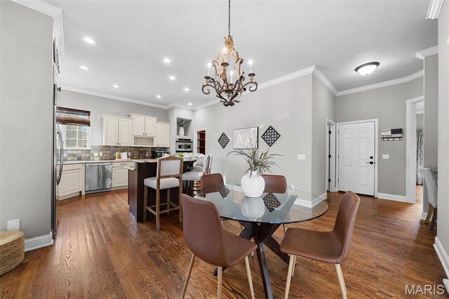 244 US Dr, Wentzville, MO 63385 - dining area featuring a chandelier, dark wood-style flooring, crown molding, recessed lighting, and baseboards