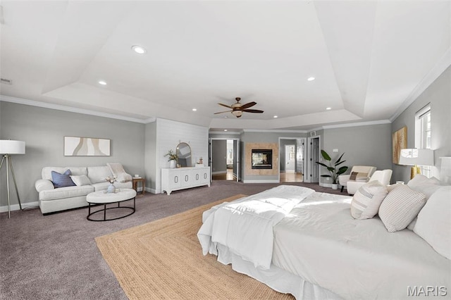 244 US Dr, Wentzville, MO 63385 - carpeted bedroom featuring a tray ceiling, recessed lighting, baseboards, ornamental molding, and a glass covered fireplace
