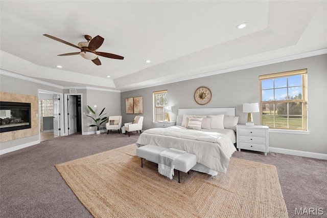 244 US Dr, Wentzville, MO 63385 - bedroom featuring a tray ceiling, baseboards, carpet floors, recessed lighting, and a multi sided fireplace