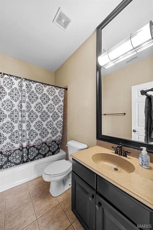 244 US Dr, Wentzville, MO 63385 - bathroom featuring toilet, tile patterned flooring, vanity, and shower / tub combo