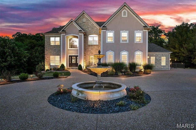 244 US Dr, Wentzville, MO 63385 - view of front of property featuring stone siding, stucco siding, and curved driveway
