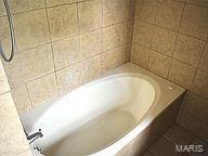 6817 Gravois Ave, Saint Louis, MO 63116 - bathroom featuring a tub to relax in and tile patterned floors