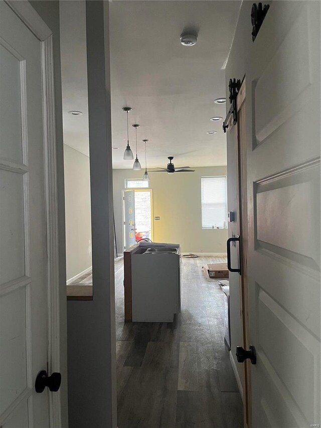 5316 Zealand St, Saint Louis, MO 63107 - hall featuring dark wood finished floors and a barn door