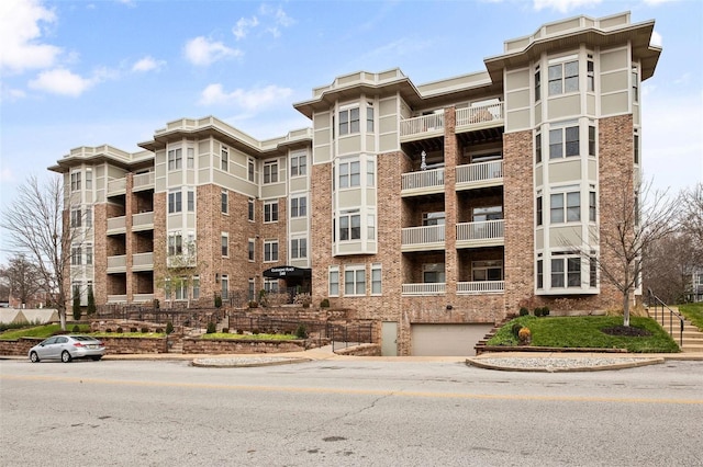 view of apartment building / complex featuring a garage